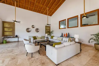 a living room with a white couch and chairs at Casa de Campo Luxury Villas - Private Paradise at La Romana in La Romana