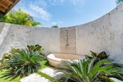 a bath tub in a garden with some plants at Casa de Campo Luxury Villas - Private Paradise at La Romana in La Romana