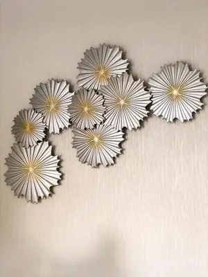 a group of five paper flowers on a wall at Hotel Sinai in Nagua