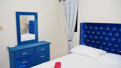a bedroom with a blue headboard and a mirror at Vistabalcon Aire y Neflix in La Guáyiga