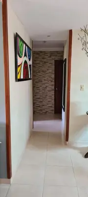 a hallway with a painting hanging on a wall at Vistabalcon Aire y Neflix in La Guáyiga