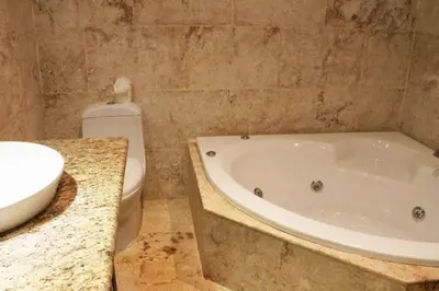 a bathroom with a tub and a toilet and a sink at Cozy and Luxurious 2 bedroom apartment in Sosúa