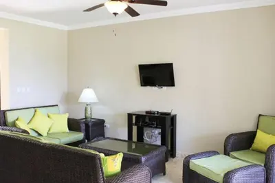 a living room with two couches and a flat screen tv at Cozy and Luxurious 2 bedroom apartment in Sosúa