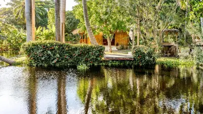 a body of water with trees and bushes at Kibayo Lagoon Villa in Cabarete