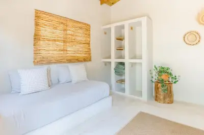a white room with a bed and a window at Kibayo Lagoon Villa in Cabarete