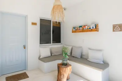 a room with a bench with a table and a window at Kibayo Lagoon Villa in Cabarete