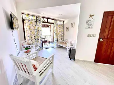 a living room with two white cribs in a room at Las Terrenas beachfront 2 bedrooms condo with pool in Las Terrenas