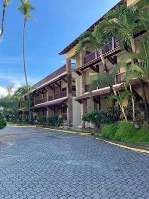 a street in front of a building with palm trees at Las Terrenas beachfront 2 bedrooms condo with pool in Las Terrenas