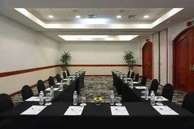 a conference room with long tables and chairs in it at Four Points by Sheraton Santo Domingo in Santo Domingo