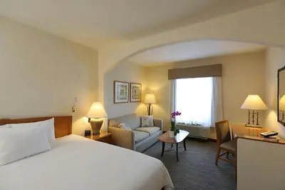 a hotel room with a bed and a couch at Four Points by Sheraton Santo Domingo in Santo Domingo