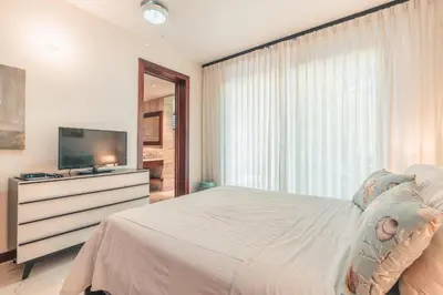 a bedroom with a bed and a television on a dresser at Newly Added 1BR El Portillo Luxury in Portillo