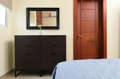 a bedroom with a dresser and a mirror at Maravilloso Apto en Santo Domingo in Santo Domingo