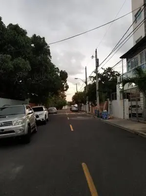 a street with cars parked on the side of the road at Maravilloso Apto en Santo Domingo in Santo Domingo