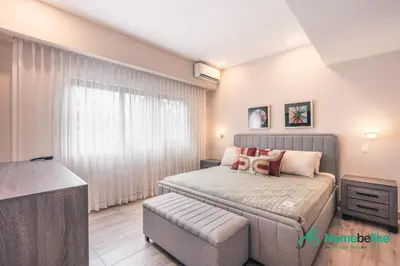 a small bedroom with a bed and a couch at Breakfast Included Fully Serviced Apartment at Regatta Living II - 204 in Santo Domingo