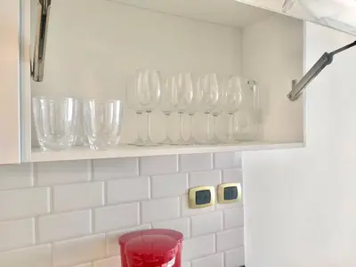 a shelf filled with glass vases on a wall at Cana Rock De Lujo 344 Vista Al Campo De Golf in Punta Cana