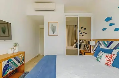 a bedroom with a large bed with blue and white sheets at Cana Rock 108 Acceso Directo Piscina Punta Cana in Punta Cana