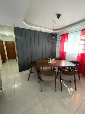 a dining room with a wooden table and chairs at 3bed Apartment con Terraza y Picsina privada in Santo Domingo