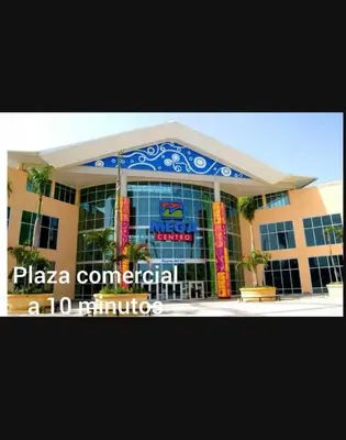 a building with a sign that reads pizza commercial a minutes at 3bed Apartment con Terraza y Picsina privada in Santo Domingo