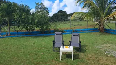 two chairs and a table in a yard at Casa A&A in Las Galeras
