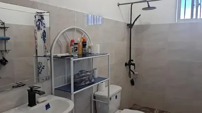 a bathroom with a toilet and a sink and a shower at Casa A&A in Las Galeras