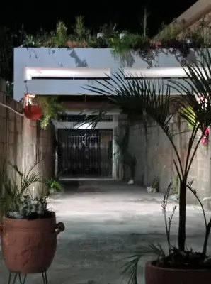 a courtyard with potted plants in front of a building at Villa Julirous Rd-spa and ApartHotel, Camp for vacationers, 2 bedrooms in Boca Chica