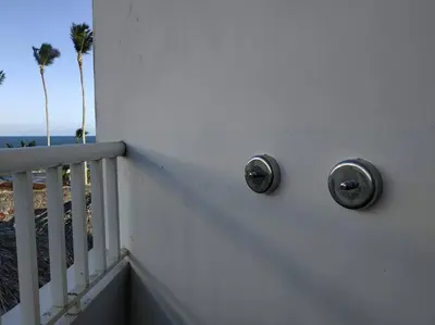 a balcony with palm trees and the ocean in the background at Modern, Welcoming Studio, Ocean View in Juan Dolio in Juan Dolio