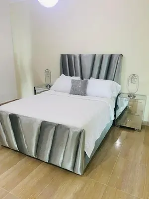 a large bed with a metal frame in a bedroom at Malecón vista mar Habitación Privada Larimar, in Santo Domingo