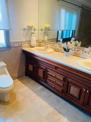 a bathroom with a sink and a toilet and a mirror at Malecón vista mar Habitación Privada Larimar, in Santo Domingo