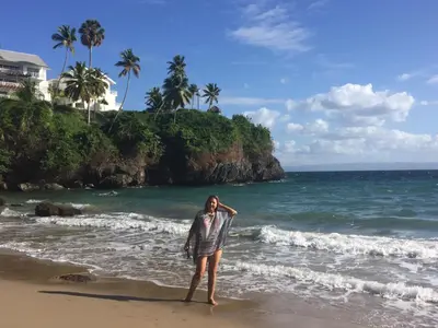 a woman standing on the beach near the ocean at Vista Mare Samana The Best View!! in Santa Bárbara de Samaná