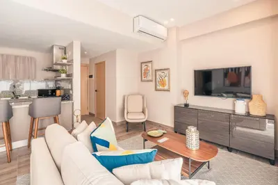 a living room with a couch and a table at Apartment at Regatta Living II - 406 fully-equipped in Los Prados