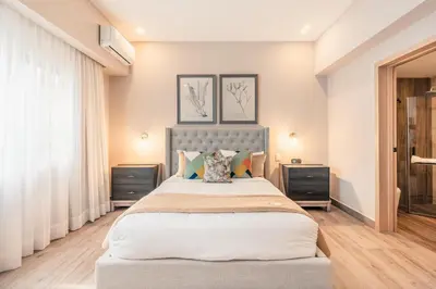 a bedroom with a large bed with two night stands at Apartment at Regatta Living II - 406 fully-equipped in Los Prados