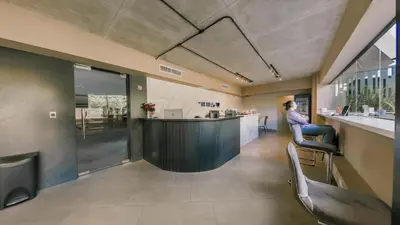 a bar in the middle of a room with chairs at Apartment at Regatta Living II - 406 fully-equipped in Los Prados