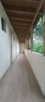 an empty hallway of a building with a wooden ceiling at guest house MY WAY in Las Terrenas