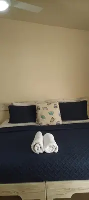a bed with two towels on top of it at guest house MY WAY in Las Terrenas