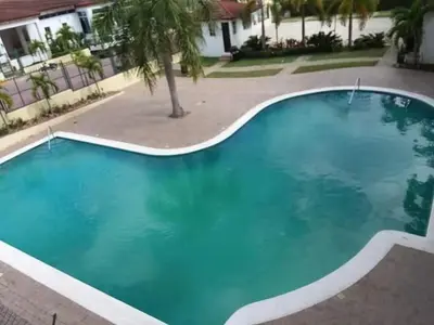 a large blue swimming pool in front of a building at Paradise s-1 3 in Santiago de los Caballeros