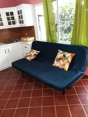 a blue couch with two pillows in a kitchen at PLAYA BLANCA BED AND BREAKFAST in Bayahibe