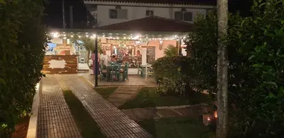 a garden at night with lights on a house at PLAYA BLANCA BED AND BREAKFAST in Bayahibe