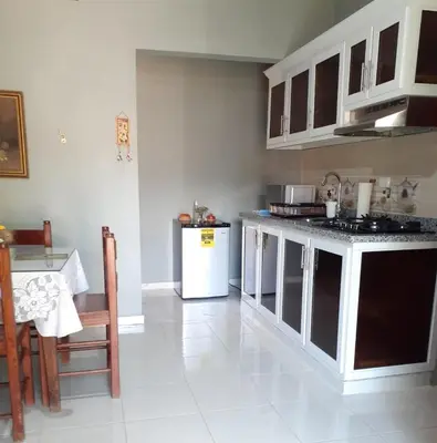 a kitchen with a white refrigerator and a table at CASITA HOGAREÑA JARABACOA (independent entrance) in Jarabacoa