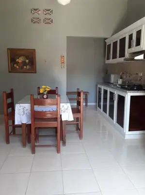 a kitchen with a table and chairs in a room at CASITA HOGAREÑA JARABACOA (independent entrance) in Jarabacoa
