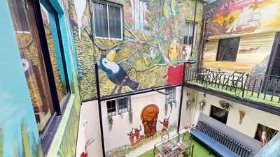 a building with a painting on the side of it at Hotel Tau Art Residence in Santo Domingo