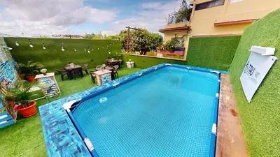 a swimming pool in the backyard of a house at Hotel Tau Art Residence in Santo Domingo
