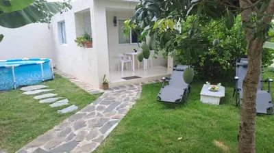 a backyard with a pool and a table and chairs at Casa taina in Jarabacoa