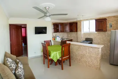 a kitchen with a table and chairs in a room at Cozy One Bedroom Apartment in Santo Domingo Este in La Viva