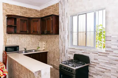 a kitchen with a stove and a window at Modern Studio Near Airport Fast WiFi Generator in La Viva
