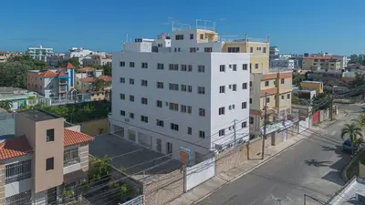 an overhead view of a white building in a city at Cozy Apartment Near Airport Wi-Fi & Parking in La Viva