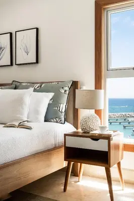 a bedroom with a bed and a table and a window at Cofresi Hills Residence in Gurapito