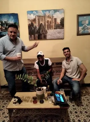 a group of three men sitting around a table at La casa de Jessica in Santo Domingo