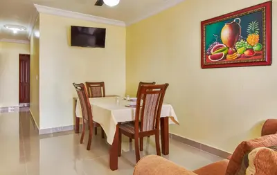 a dining room with a table and chairs and a picture on the wall at Spacious 2Br 1Bath Apartment Terrace & Street View in La Viva