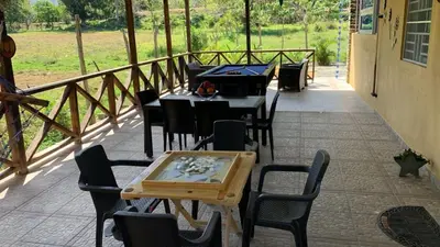 a group of tables and chairs on a patio at Villa La Grande in Jarabacoa