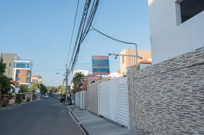 an empty street with a brick wall next to a building at 1 Bedroom Apartment 1 Queen 2 Singles in La Viva